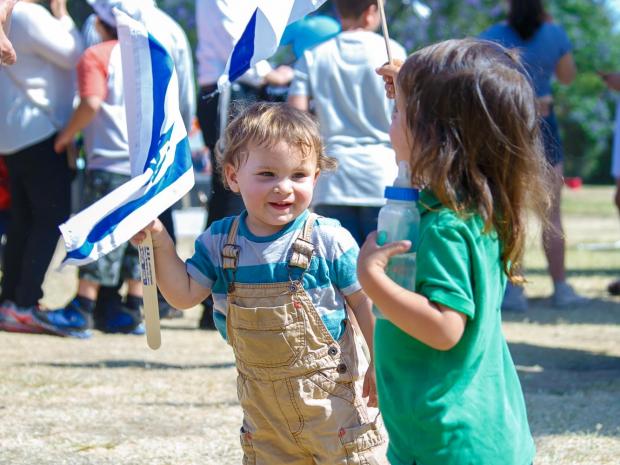 photo of two children holding the Israel flag 