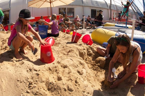 people making sand sculpture with pails