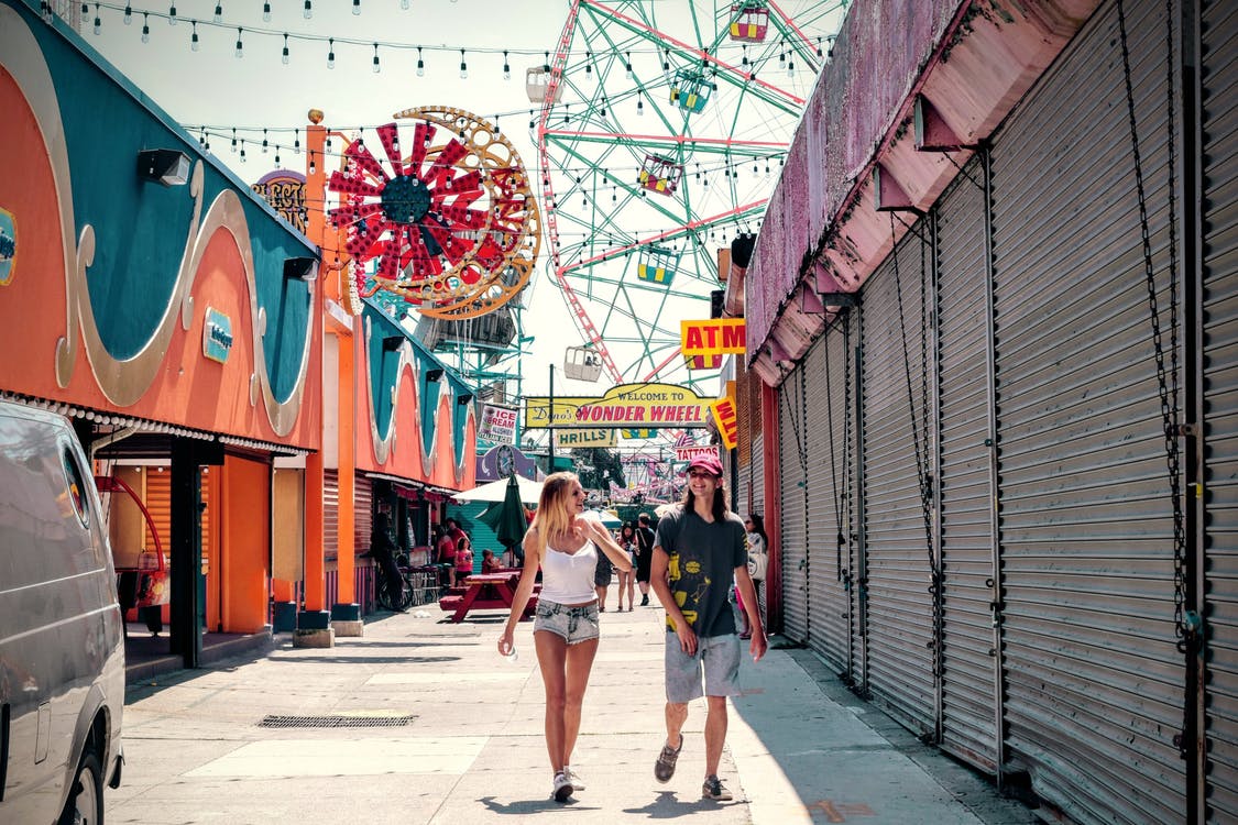 men and women walking at the carnival