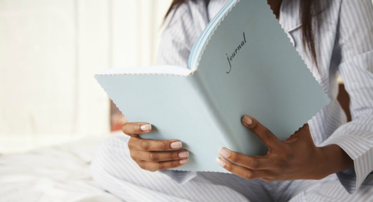 woman looking at journal