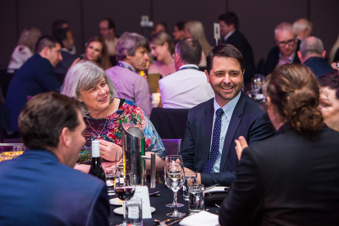 people talking at a table at an event