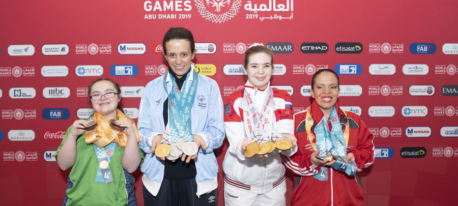 four women showing off their medals