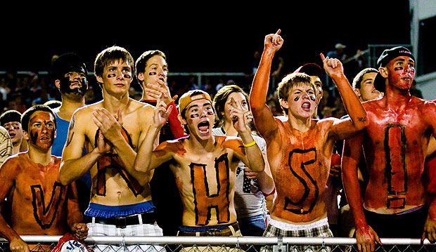 sports fans covered in body paints cheering