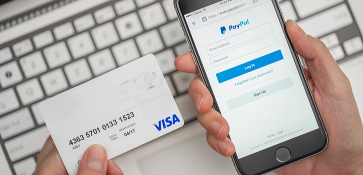a visa card and a PayPal account set up on a mobile site