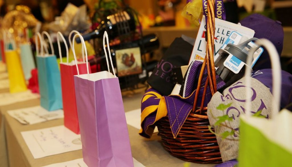 paper bags in different colors and a basket and wine
