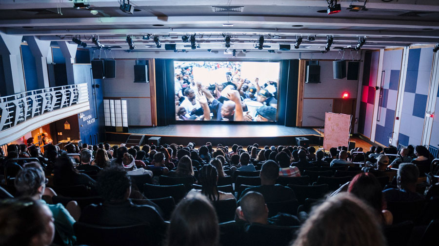 a crowd of people watching a film