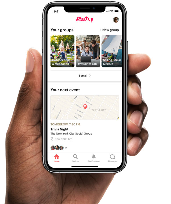 hand holding a mobile phone with Meetup on the screen