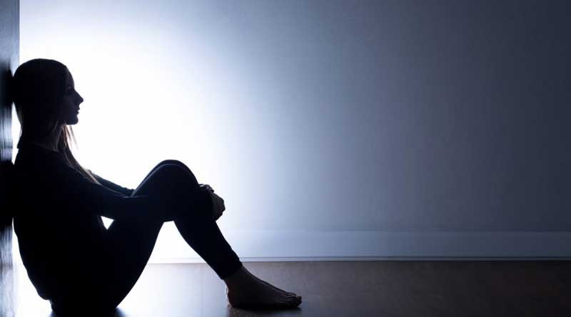 woman sitting alone in the dark room