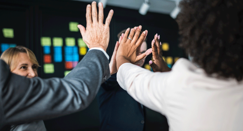 employees giving each other high five