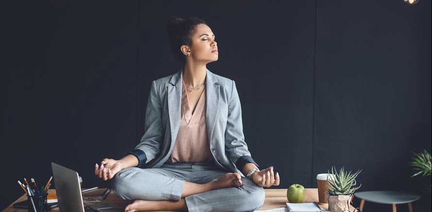 a woman wearing business suit meditating
