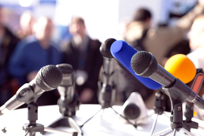 media press conference setup by the reporters and their microphone