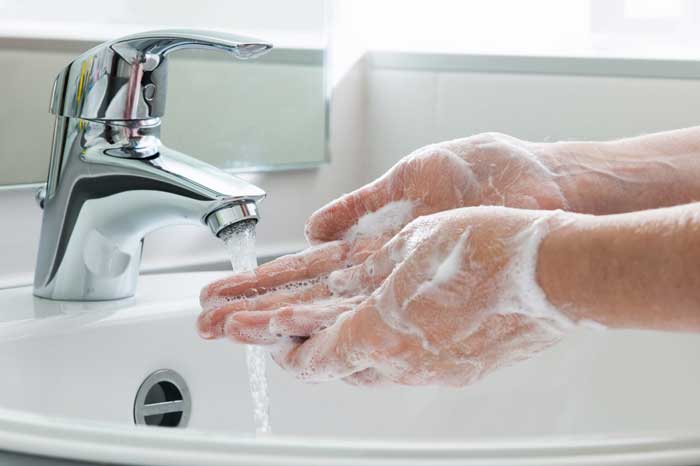 washing hands on a lavatory to avoid the virus
