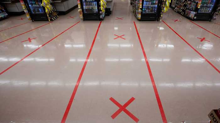 a floor tape with red X mark used for social distancing at grocery store