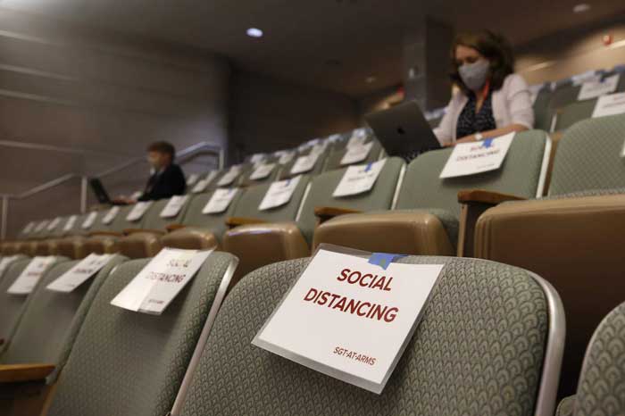 assigned seating at the auditorium with social distancing signage for each chairs