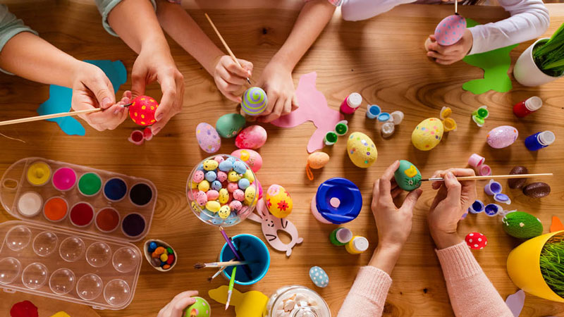 a group of kids doing egg arts and crafts