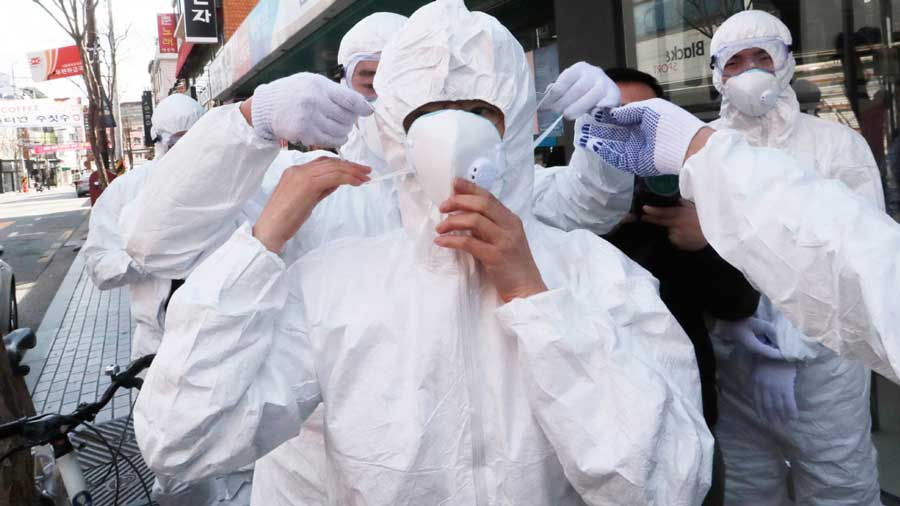 a group of health workers wearing personal protective equipment