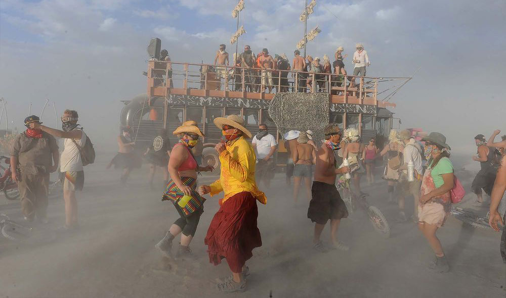 group of people dancing in the burning man event