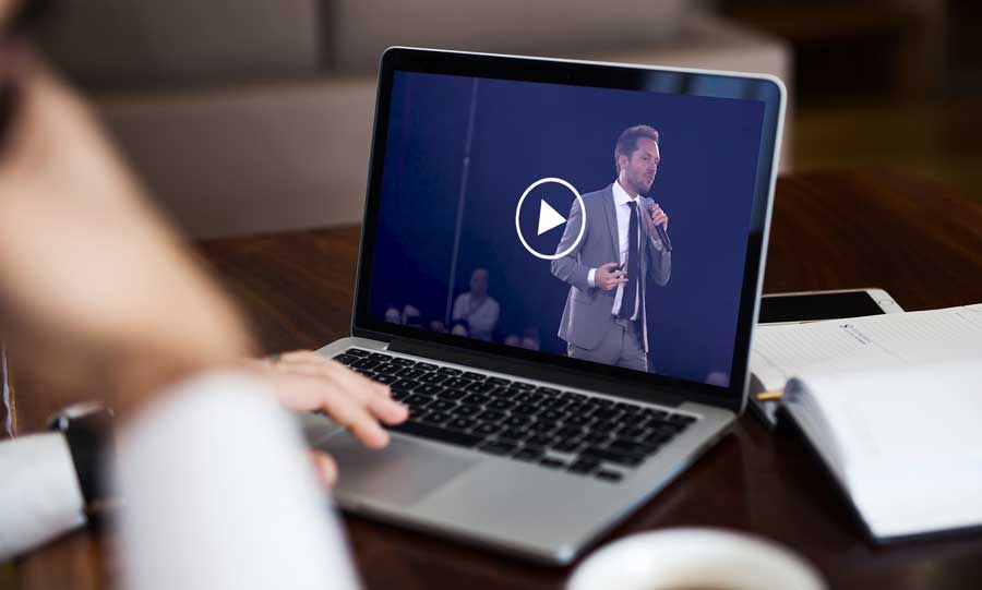 play button on a laptop with a guy holding a microphone