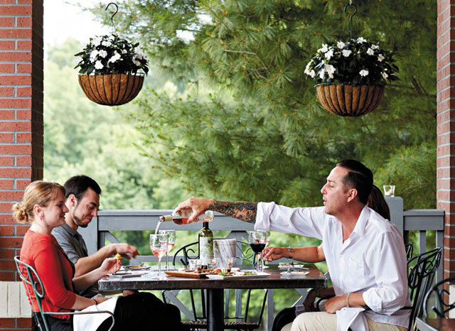 couple and man eating at a restaurant outdoors