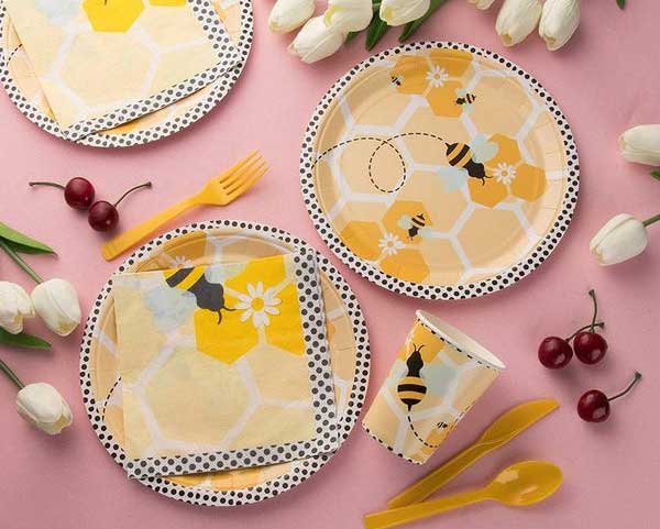 yellow paper plates with design and pink color background 