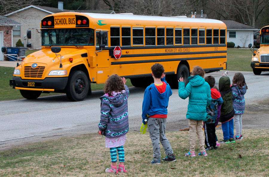 kids waiting for a school bus