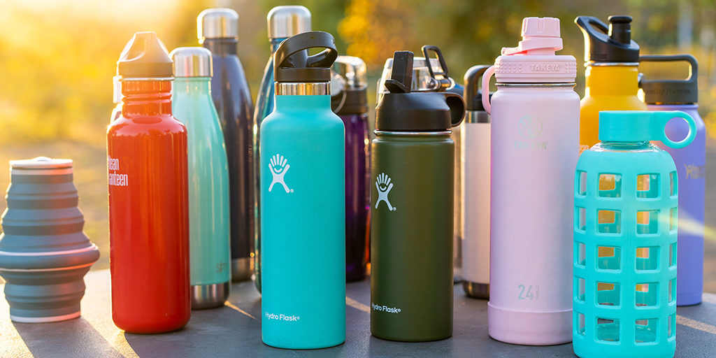 a bunch of reusable water bottles sitting outside on a table