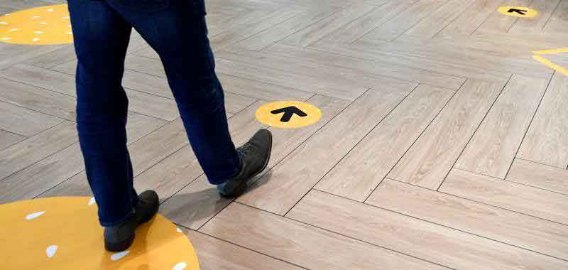 a-man-following-arrows-on-the-floor