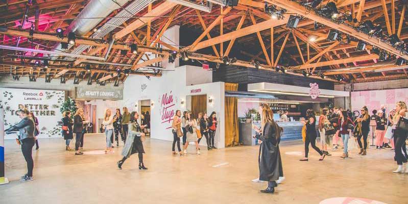 people walking around at an event in a big room