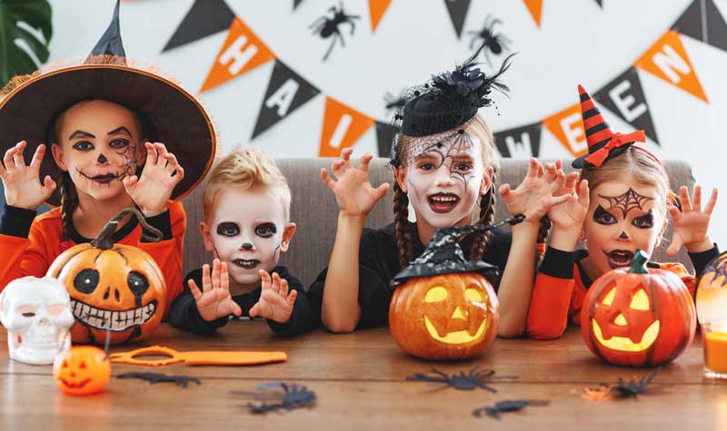 Kids-dressed-in-Halloween-costumes-with-pumpkins-on-their-face