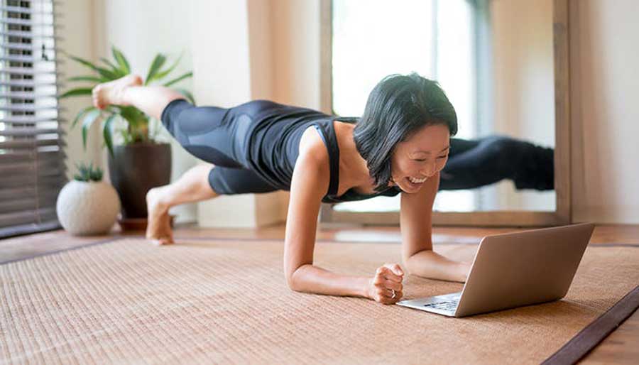 a-woman-working-out-to-an-online-fitness-class