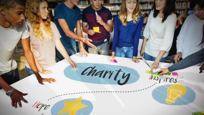 people-standing-around-a-sign-for-charity