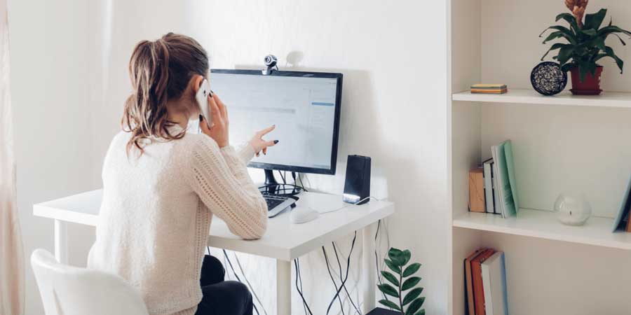 a-girl-pointing-to-her-computer-on-the-phone