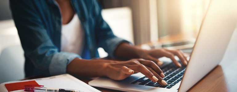 a-woman-typing-on-her-computer