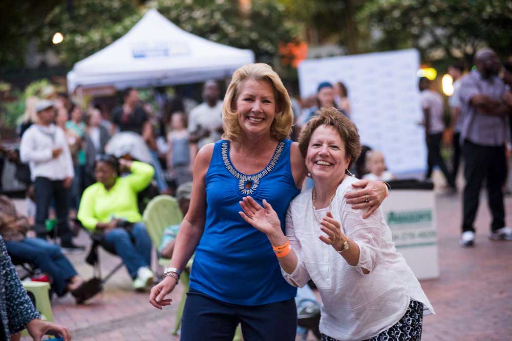 woman-smiling-clapping-outside-at-an-event