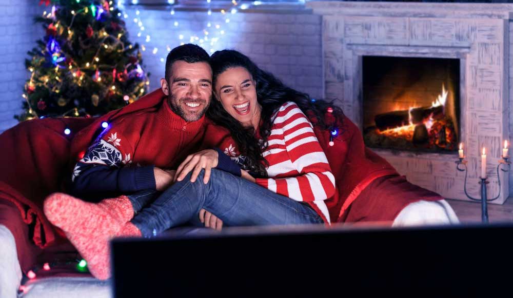 a-couple-watching-tv-during-the-holiday-season