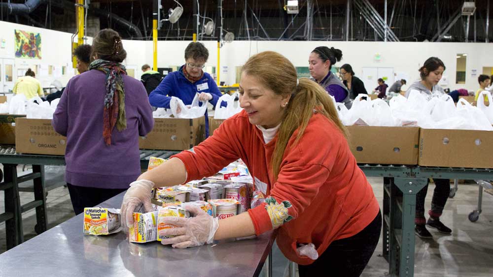 a-woman-collecting-donations-at-a-food-bank