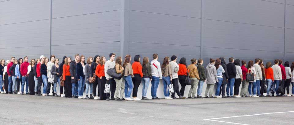 people-standing-in-line-outside-a-building