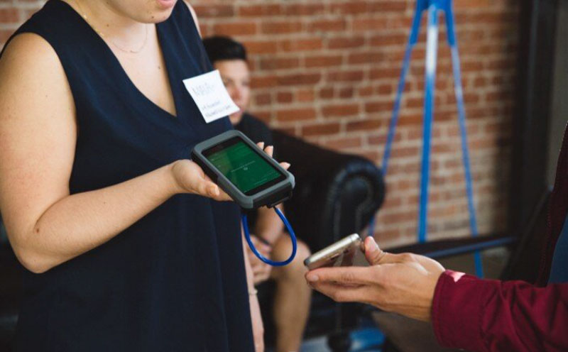 A-woman-scanning-someones-phone-with-QR-codes