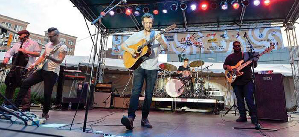 a-man-playing-a-guitar-on-stage