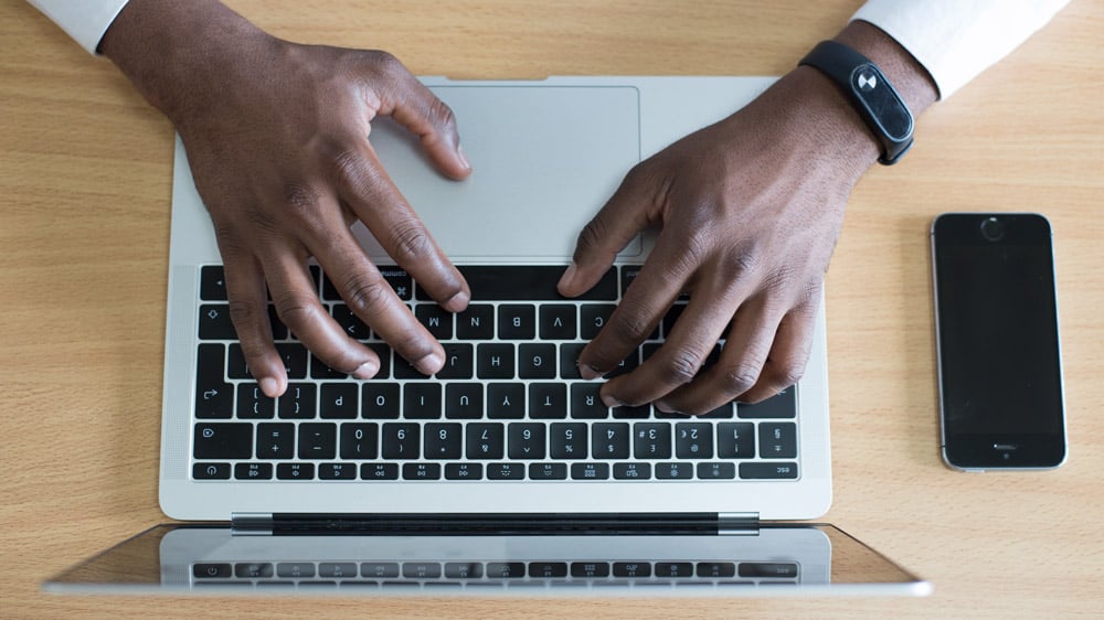 a-man-typing-on-his-computer