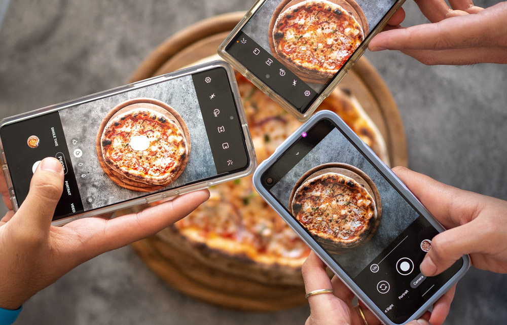 people-taking-photos-of-their-pizza