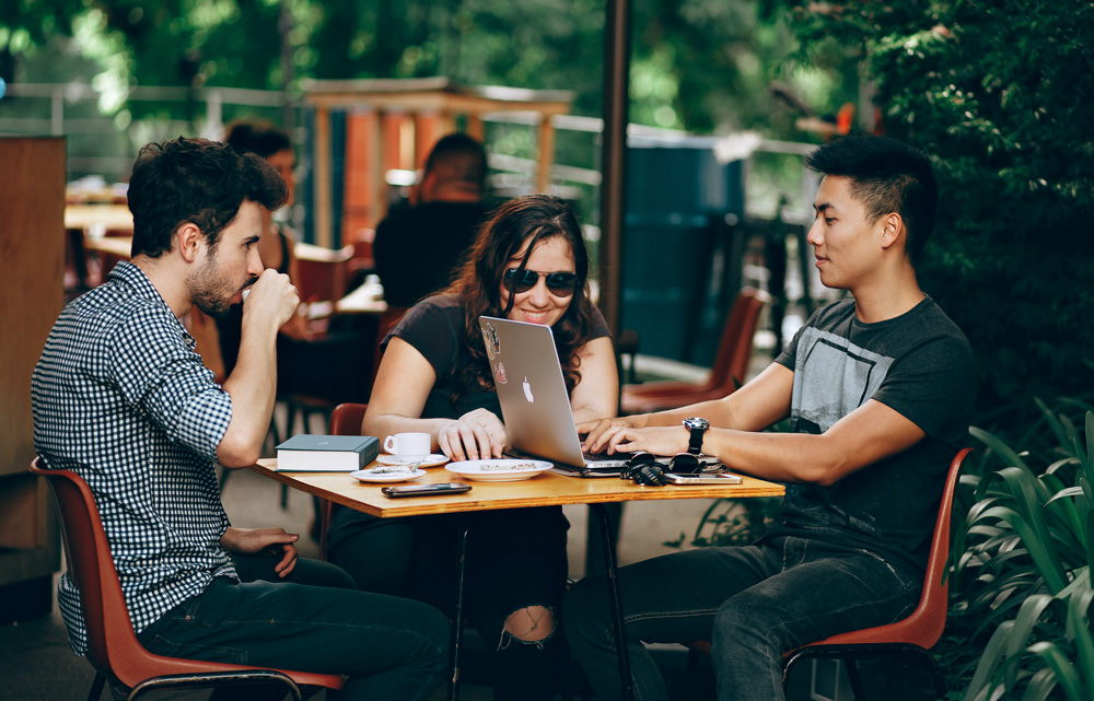 students-working-on-computers-at-a-coffee-shop---Millennials