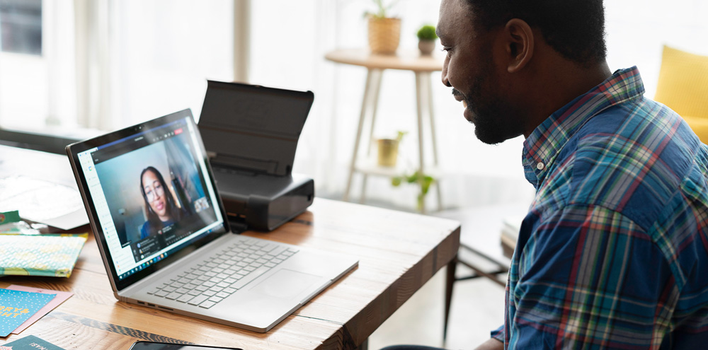 a-man-on-a-laptop-attending-a-show